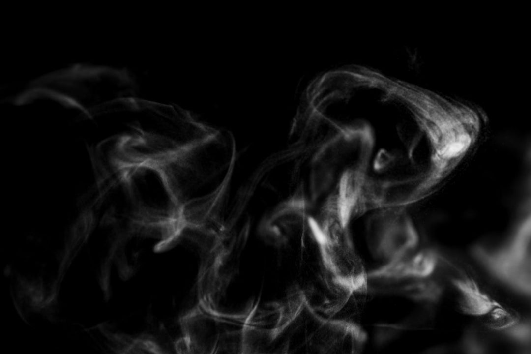Wisps of vape smoke in the vague shape of a face 